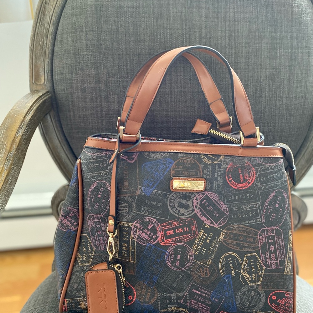 Handheld bag, brown, with red, purple gold, light brown,grey little tags on it